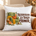 Beli jastuk sa zelenom foteljom, žutim prekrivačem i natpisom Rezervisano za bakin odmor na bež sofi
